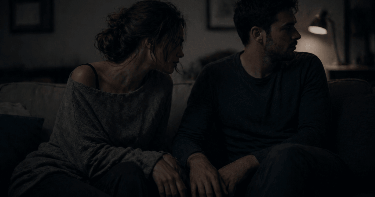 what is avoidant attachment and why does loving an avoidant hurt so much – two people sitting close on a couch but emotionally distant, showing lack of connection and subtle withdrawal